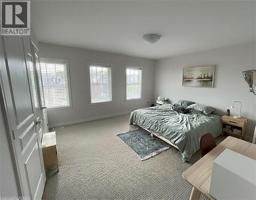 3rd floor primary bedroom with his/her closet, blinds, carpet flooring (old photo) - 352 Louisa Street, Kitchener, ON - Indoor Photo Showing Bedroom