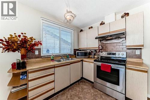 208 Bracewood Road Sw, Calgary, AB - Indoor Photo Showing Kitchen With Double Sink