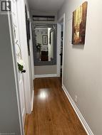 Hall with dark wood finished floors and a textured ceiling - 