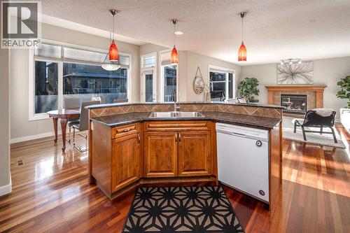 135 Everglade Circle Sw, Calgary, AB - Indoor Photo Showing Kitchen With Fireplace With Double Sink