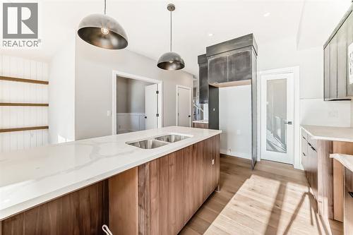 504 Heritage Boulevard, Cochrane, AB - Indoor Photo Showing Kitchen With Double Sink