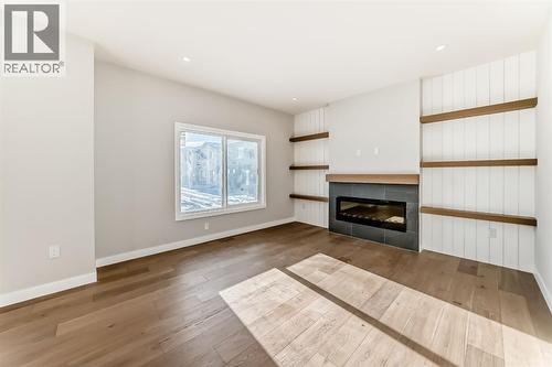 504 Heritage Boulevard, Cochrane, AB - Indoor Photo Showing Living Room With Fireplace