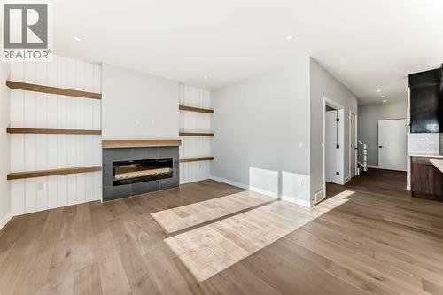 504 Heritage Boulevard, Cochrane, AB - Indoor Photo Showing Living Room With Fireplace