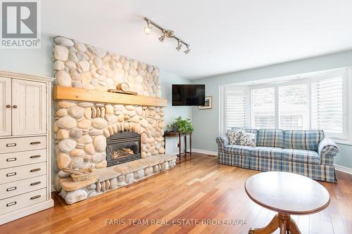 32 Cairns Boulevard, Springwater, ON - Indoor Photo Showing Living Room With Fireplace