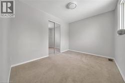 Unfurnished bedroom with a closet, carpet floors, and a textured ceiling - 