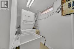 Laundry area with estacked washer and dryer and a heating unit - 