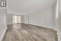 Spare room featuring crown molding and light wood finished floors - 