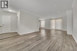 Unfurnished room with ornamental molding and light wood-style floors - 