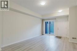 Empty room featuring visible vents, baseboards, and light wood finished floors - 