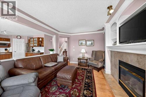 206 Cougarstone Circle Sw, Calgary, AB - Indoor Photo Showing Living Room With Fireplace