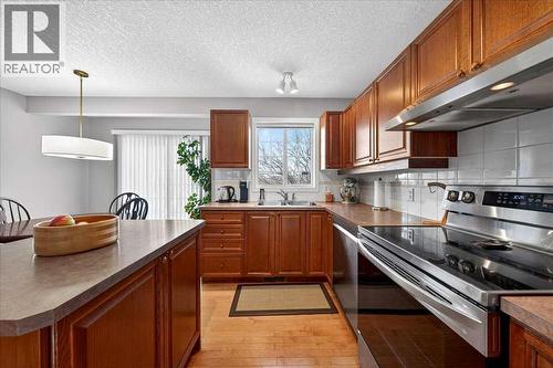 206 Cougarstone Circle Sw, Calgary, AB - Indoor Photo Showing Kitchen With Double Sink