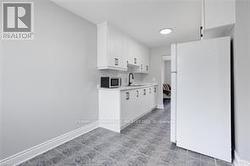 Kitchen with sink cabinetry, white refrigerator - 