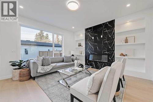 8136 47 Avenue Nw, Calgary, AB - Indoor Photo Showing Living Room With Fireplace