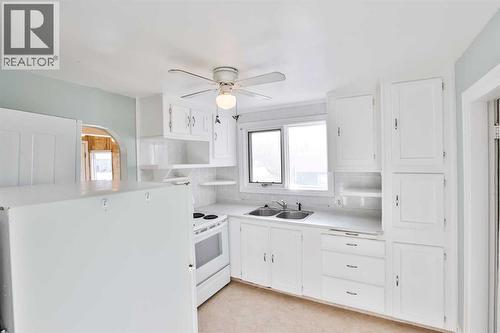 236 N 100 W, Raymond, AB - Indoor Photo Showing Kitchen With Double Sink