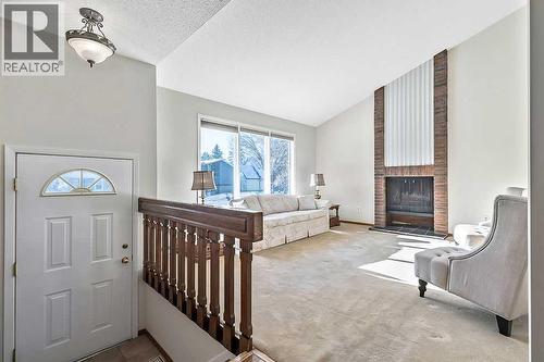 107 Lock Crescent, Okotoks, AB - Indoor With Fireplace