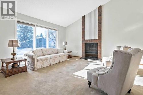 107 Lock Crescent, Okotoks, AB - Indoor Photo Showing Living Room With Fireplace