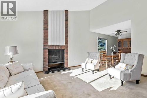 107 Lock Crescent, Okotoks, AB - Indoor Photo Showing Living Room With Fireplace