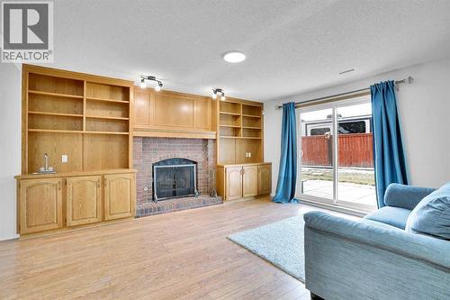 143 Millview Court Sw, Calgary, AB - Indoor Photo Showing Living Room With Fireplace