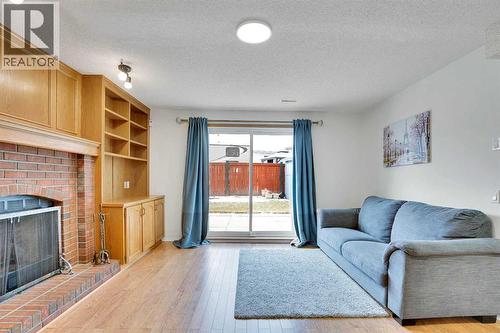 143 Millview Court Sw, Calgary, AB - Indoor Photo Showing Living Room With Fireplace