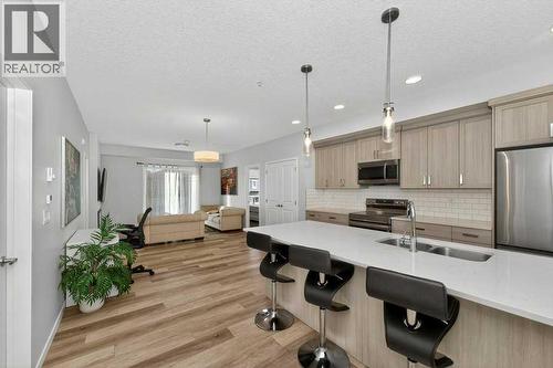 1207, 33 Carringham Gate Nw, Calgary, AB - Indoor Photo Showing Kitchen With Stainless Steel Kitchen With Double Sink With Upgraded Kitchen