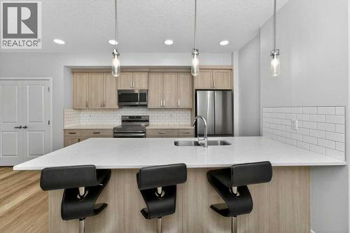 1207, 33 Carringham Gate Nw, Calgary, AB - Indoor Photo Showing Kitchen With Stainless Steel Kitchen With Double Sink With Upgraded Kitchen