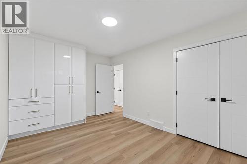 Primary bedroom upstairs with separate custom closet - 420 Pinegreen Close Ne, Calgary, AB - Indoor Photo Showing Other Room