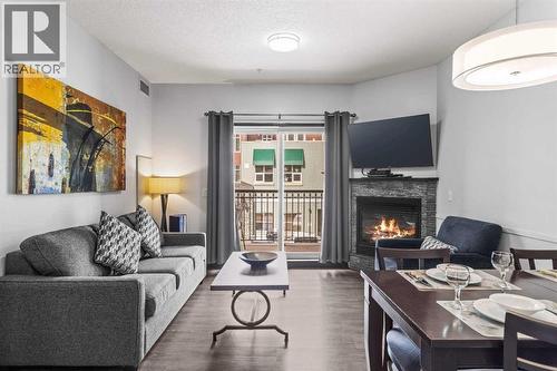 205 Rot. A, 901 Mountain Street, Canmore, AB - Indoor Photo Showing Living Room With Fireplace