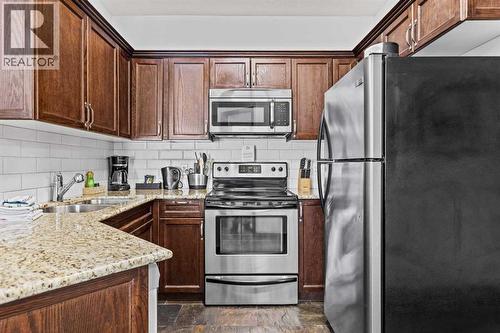 205 Rot. A, 901 Mountain Street, Canmore, AB - Indoor Photo Showing Kitchen With Stainless Steel Kitchen With Double Sink