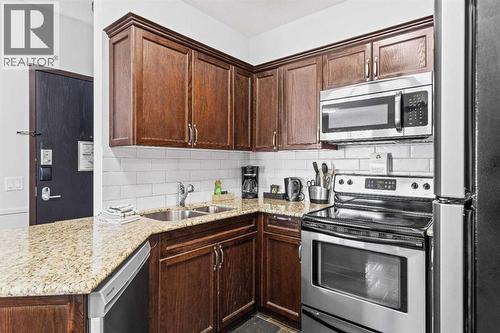205 Rot. A, 901 Mountain Street, Canmore, AB - Indoor Photo Showing Kitchen With Stainless Steel Kitchen With Double Sink