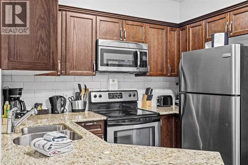 205 Rot. A, 901 Mountain Street, Canmore, AB - Indoor Photo Showing Kitchen With Stainless Steel Kitchen With Double Sink With Upgraded Kitchen