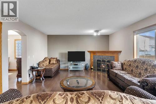 717 Coral Springs Boulevard Ne, Calgary, AB - Indoor Photo Showing Living Room With Fireplace