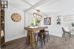 Dining room featuring dark wood finished floors and baseboards - 
