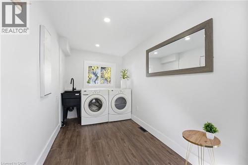 Washroom with dark wood-style flooring, recessed lighting, and independent washer and dryer - 4255 William Street, Beamsville, ON - Indoor Photo Showing Laundry Room