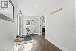 Hallway with dark wood finished floors and recessed lighting - 