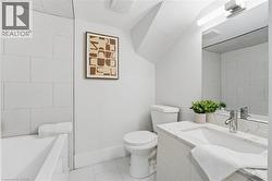 Bathroom with tile patterned flooring, vanity, and a bathtub - 