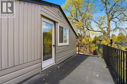 View of property exterior with board and batten siding and a patio area - 