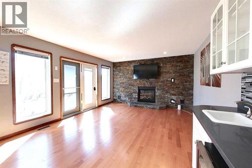 23 Springwood Drive Ne, Slave Lake, AB - Indoor Photo Showing Other Room With Fireplace