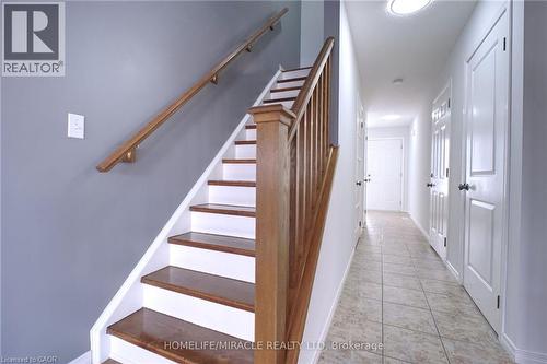 Stairway with tile patterned flooring and baseboards - 919 Zeller Crescent, Kitchener, ON - Indoor Photo Showing Other Room