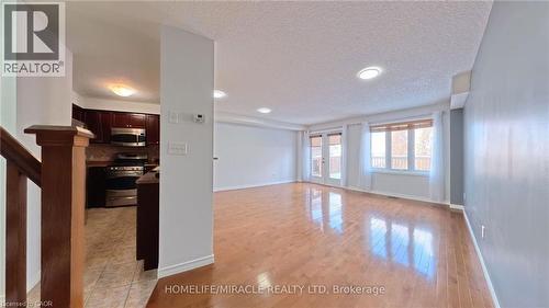 Unfurnished living room with light wood finished floors, a textured ceiling, french doors, and recessed lighting - 919 Zeller Crescent, Kitchener, ON - Indoor Photo Showing Other Room
