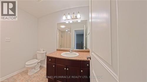 Bathroom featuring vanity, tiled shower, and light tile patterned floors - 919 Zeller Crescent, Kitchener, ON - Indoor Photo Showing Bathroom