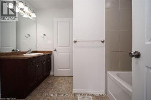 Full bath with vanity and light tile patterned floors - 919 Zeller Crescent, Kitchener, ON - Indoor Photo Showing Bathroom
