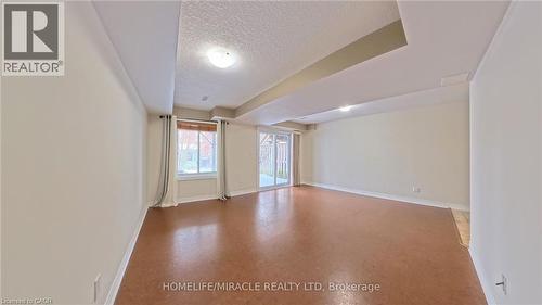 Unfurnished room featuring a textured ceiling and baseboards - 919 Zeller Crescent, Kitchener, ON - Indoor Photo Showing Other Room