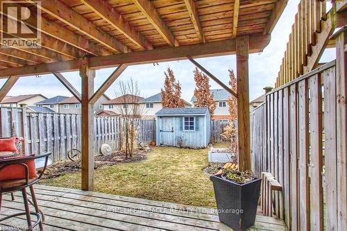 Wooden deck featuring a storage unit, a fenced backyard, and a residential view - 919 Zeller Crescent, Kitchener, ON - Outdoor With Deck Patio Veranda