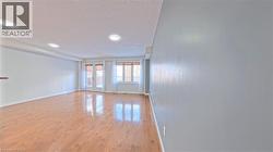 Spare room with a textured ceiling, light wood-style flooring, and french doors - 