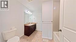 Bathroom featuring vanity and light tile patterned flooring - 
