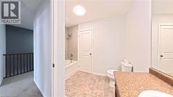 Full bath featuring shower / tub combination, vanity, and light carpet - 