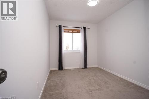 Unfurnished room featuring light colored carpet and a textured ceiling - 919 Zeller Crescent, Kitchener, ON - Indoor Photo Showing Other Room