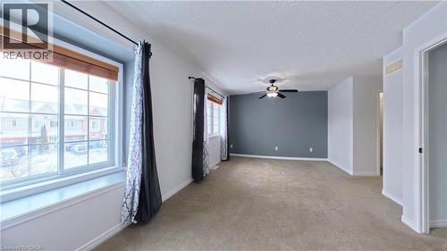 Spare room featuring a textured ceiling, light colored carpet, and ceiling fan - 919 Zeller Crescent, Kitchener, ON - Indoor Photo Showing Other Room