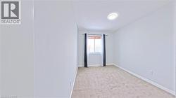 Unfurnished room featuring a textured ceiling and light colored carpet - 