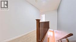 Stairway featuring baseboards and carpet - 